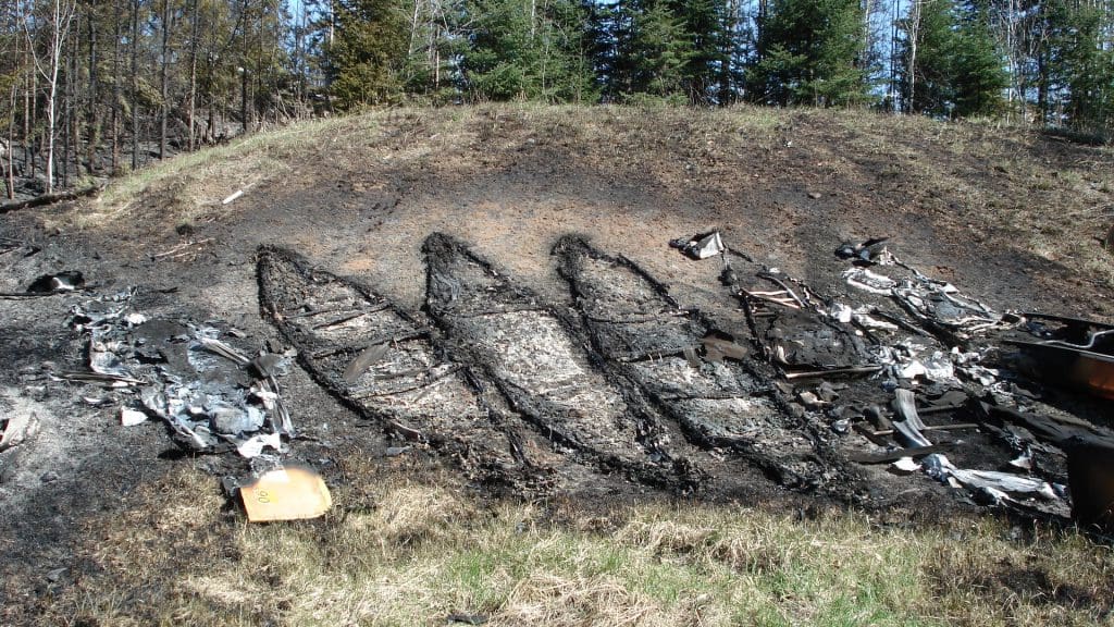 Ash outlines of canoes after the Ham Lake Fire. Photo courtesy of WTIP, North Shore Community Radio in Grand Marais.