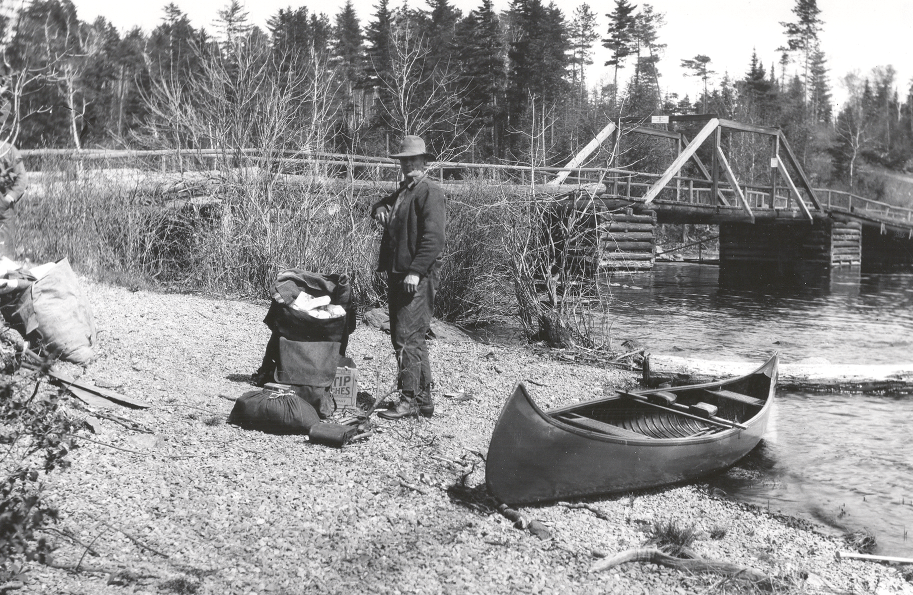 May 1921 White Iron Rapids. Ranger Matt Soderbeck loading up for the 24 day trip into the Roadless Area of the Superior National Forest. Photo by Arthur Carhart, and courtesy of Iron Range Research Center collection. 