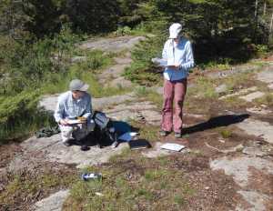 Researchers perform measurements and collect other data about campsite impacts in the Boundary Waters during the 2014 study.