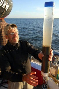Scientist Mark Edlund recovers a short gravity core from Buffalo Bay, Lake of the Woods