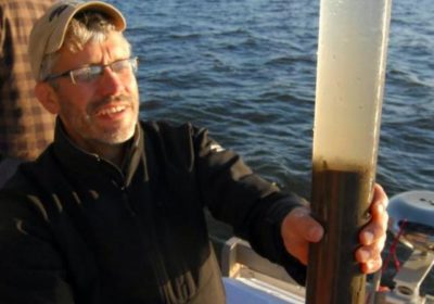 Scientist Mark Edlund recovers a short gravity core from Buffalo Bay, Lake of the Woods