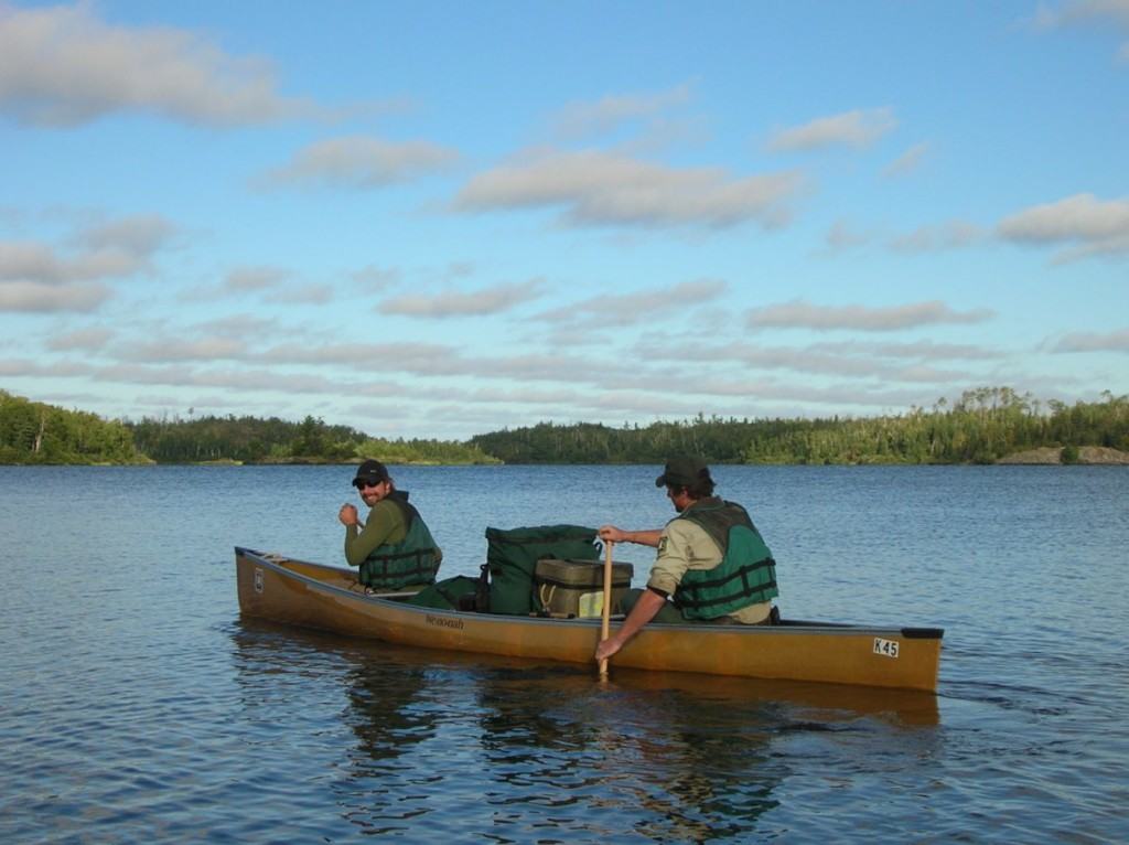 Volunteer Thompson Blodgett (bow) and ranger Curt McEwen paddle on Ensign Lake. 