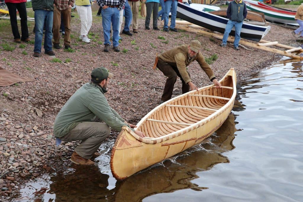 Craftsmen at the North House Folk School launch a handmade birch bark canoe in honor of the school's 20th anniversary. <br>Photo courtesy the North House Folk School.