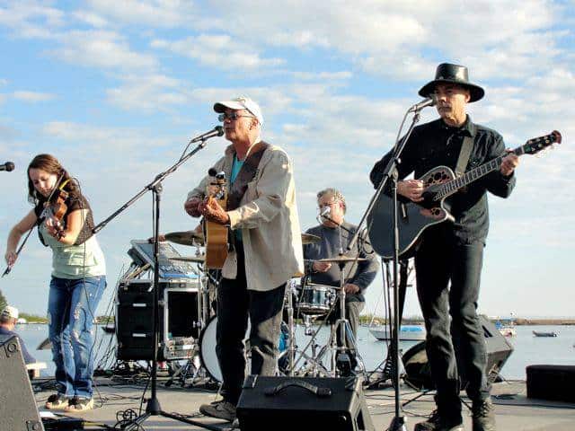 Jerry and The One Match Band playing at the Grand Marais Fisherman's Picnic with Lake Superior in the background. Photo courtesy Jerry Vandiver.