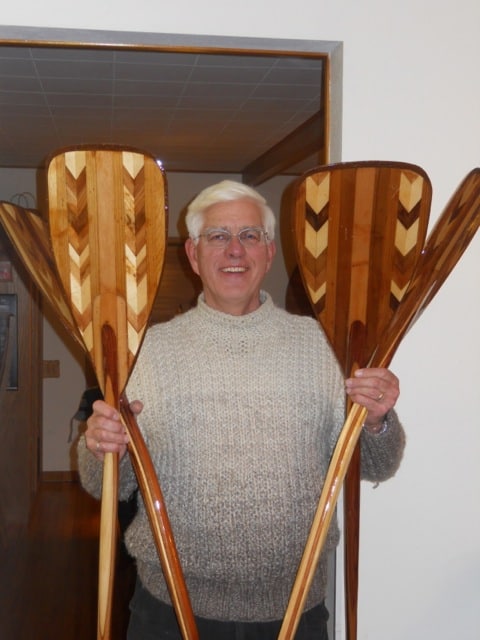 Ken Koscik and handmade paddles. Photo courtesy North House Folk School.