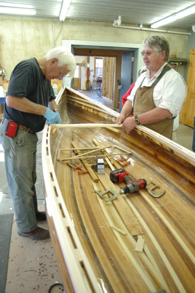 Installing thwarts on a canoe. Photo courtesy North House Folk School.