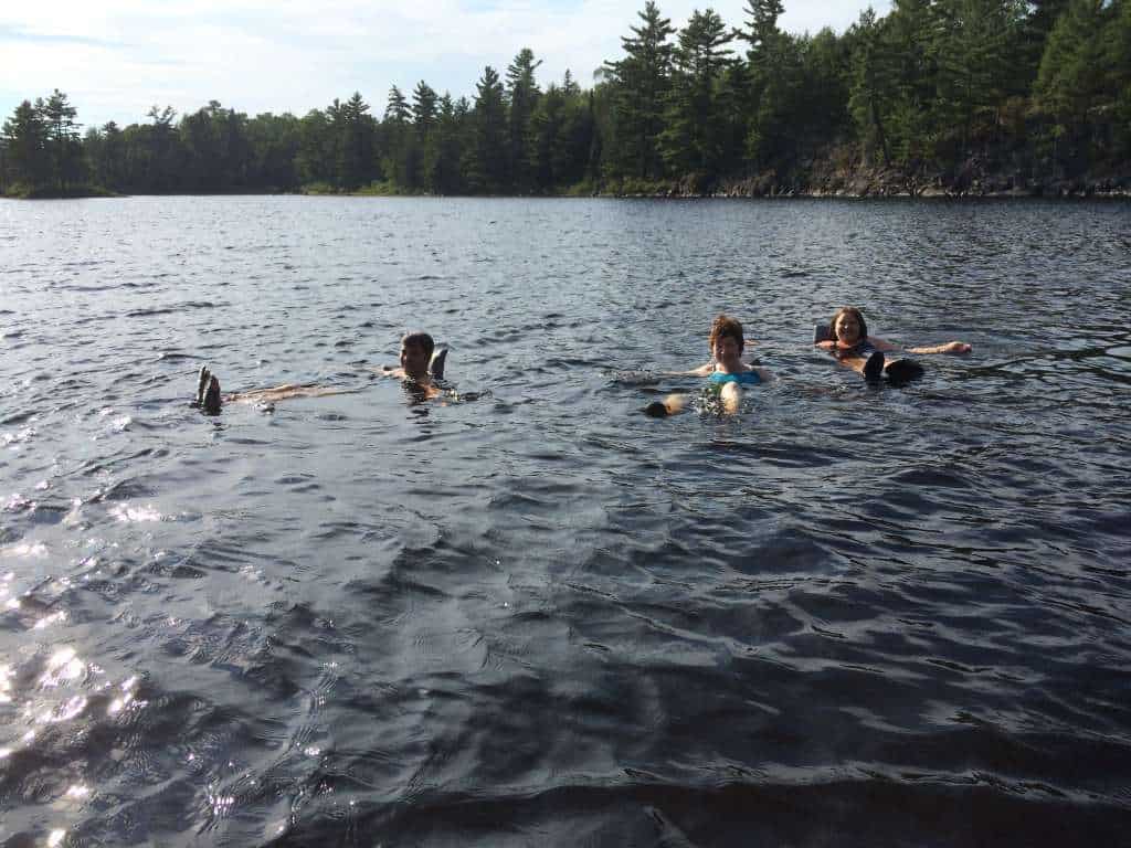 Nancy Sorenson swims with her daughter and granddaughter in the Boundary Waters. Photo by Peta Barrett.