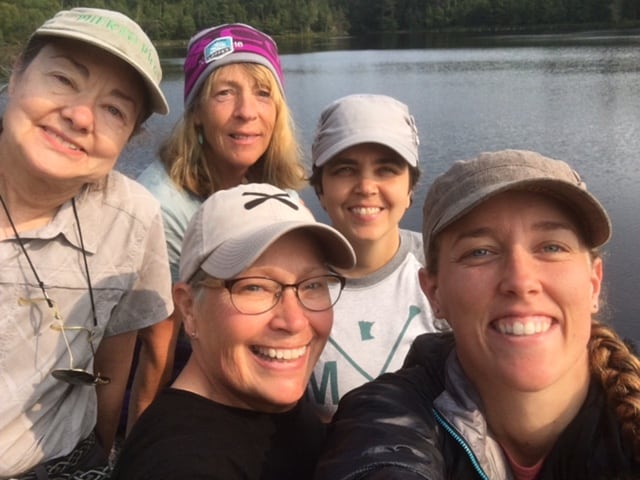 Sherelyn Ogden (pink hat) and Peta Barrett (front center) and the group at their base camp on Lower Pauness Lake. Photo by Peta Barrett.