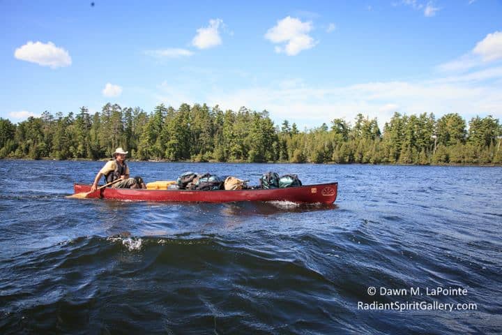 Gary Fiedler paddling a fully-loaded canoe. (Photo by Dawn LaPointe, Radiant Spirit Gallery)