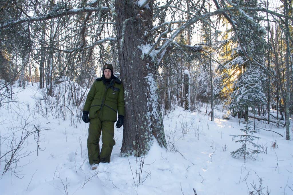 Austin Homkes standing next to the champion jack pine. (Photo by Tom Gable)