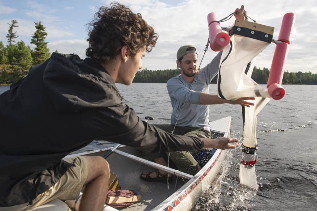 UW-Eau Claire students Reed Kostelny (left) and Thomas Adams are part of a research team that found microplastics in earthworms, water and soil in the Boundary Waters.