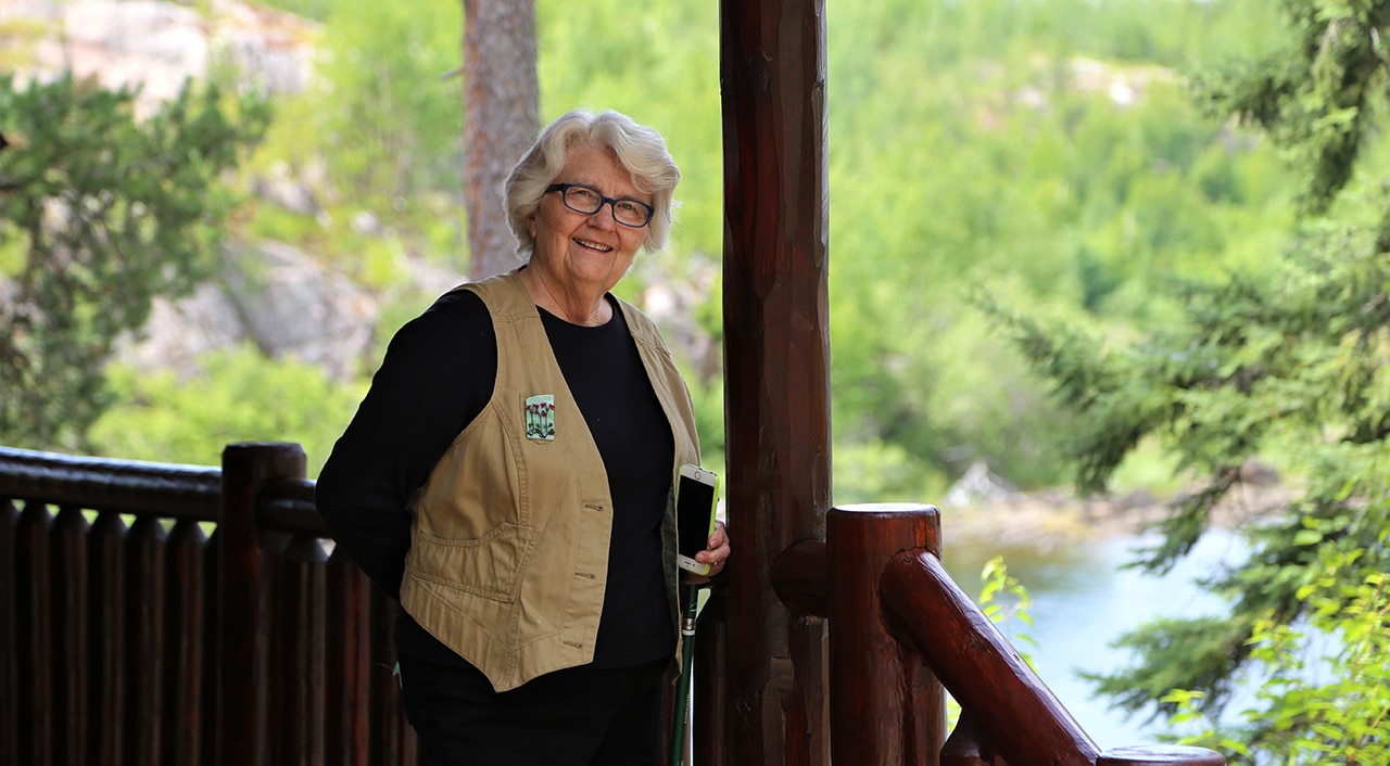 Betty on Chik Wauk Cabin front porch, photograph by Anne Queenan