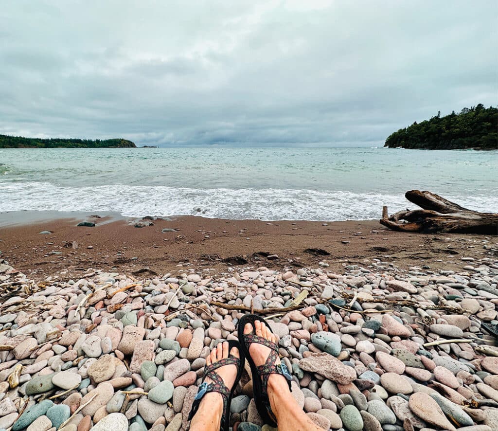 Feet on a pebble beach along Lake Superior