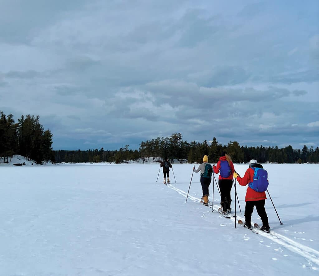 Group skiiing across a frozen lake in the BWCA