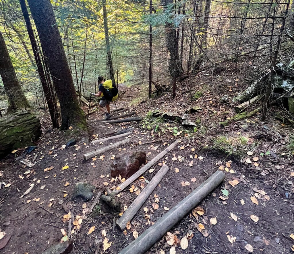 Hiker going downhill steps on Superior Hiking Trail