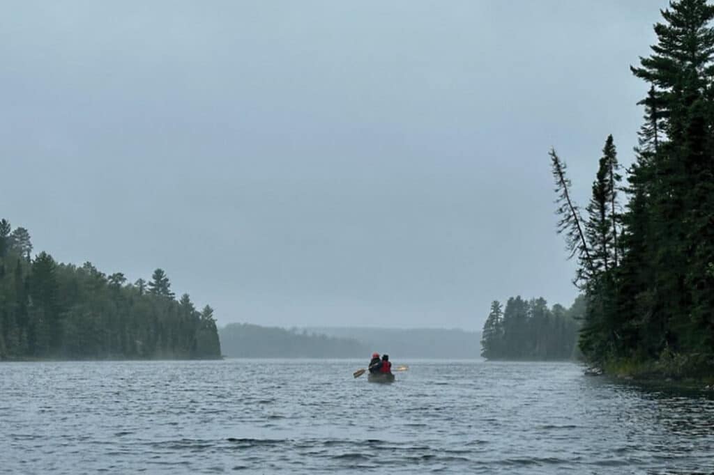 Canoe paddlers on a foggy lake in BWCA