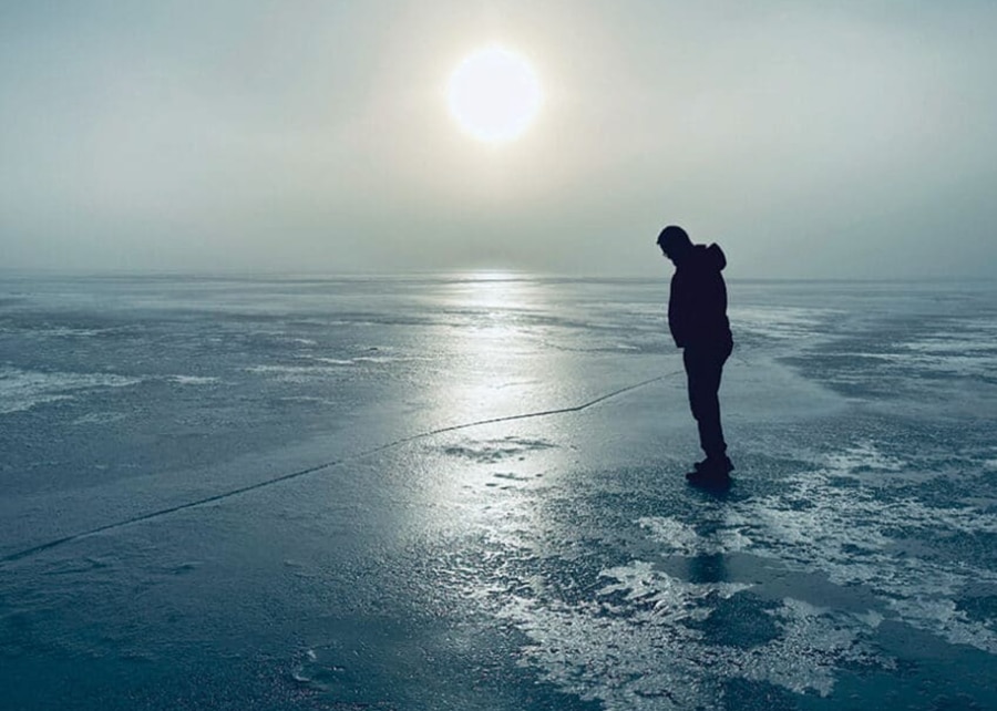 person looking at ice on MN lake