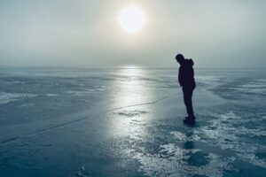 person looking at ice on MN lake