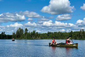 canoeists paddling on Boundary Waters lake